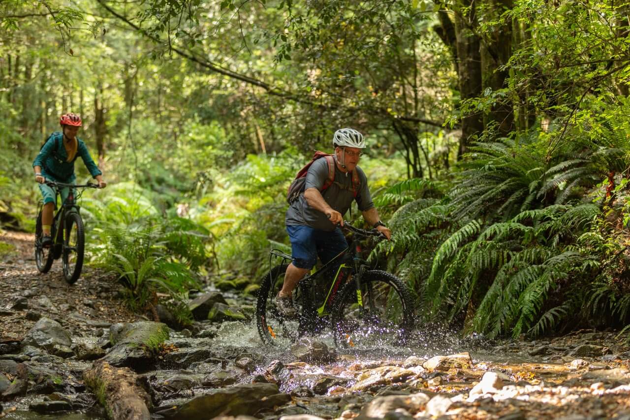 Couple mountain biking the Tree Trunk Gorge Kaimanawa Forest Park