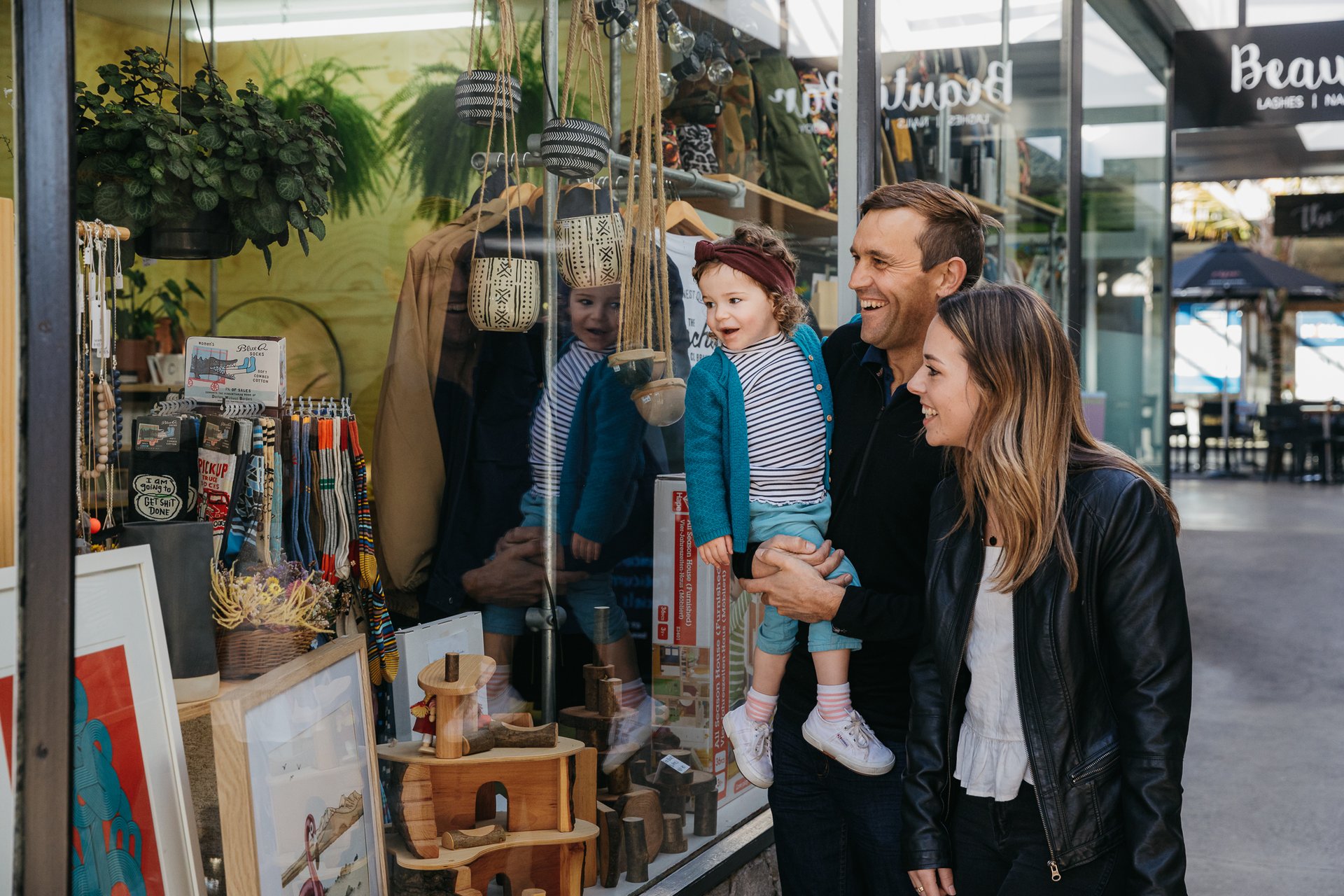 Family window shopping at Spacecraft in Taupo, New Zealand