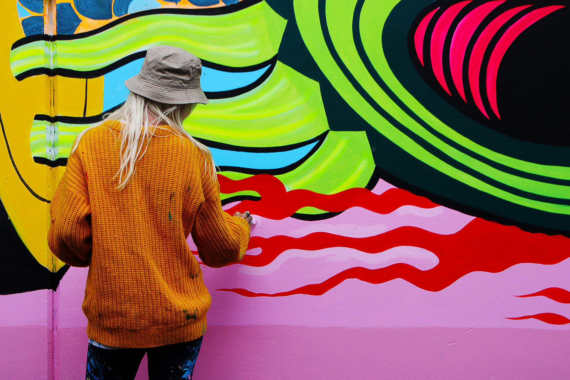Gina Kiel painting a mural at Graffiato: Taupo Street Art Festival 2019