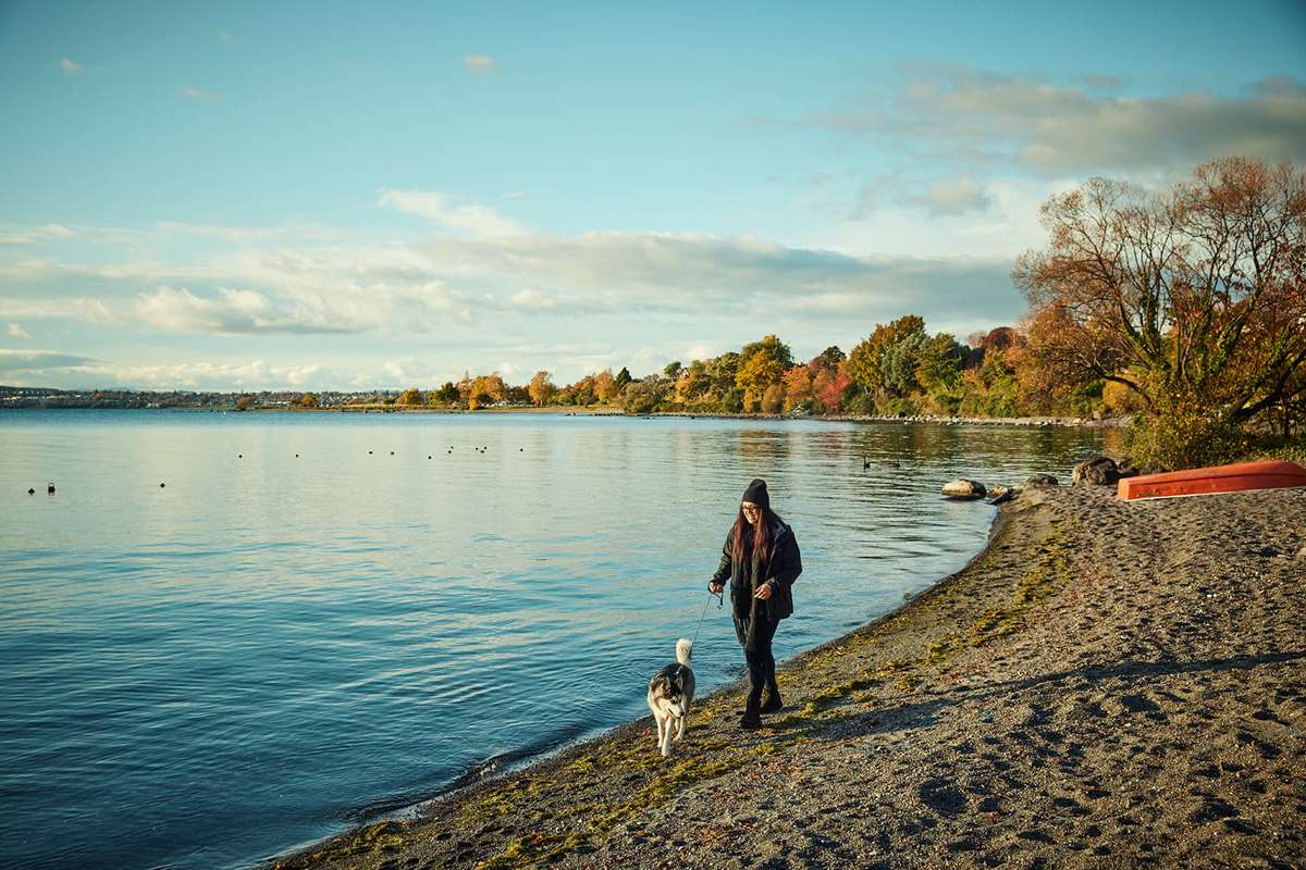 Woman walking her dog at Wharewaka, Lake Taupo - By Todd Eyre