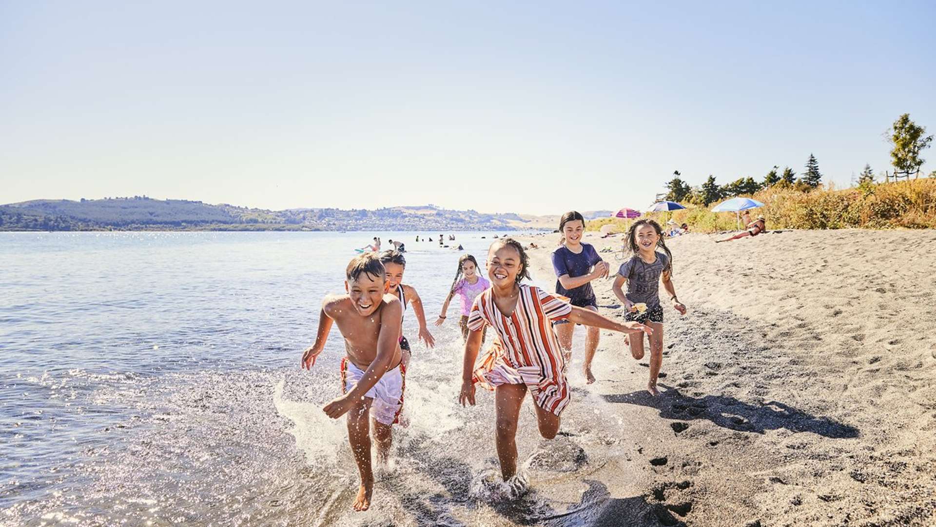 Children playing at Wharewaka beach in Lake Taupō